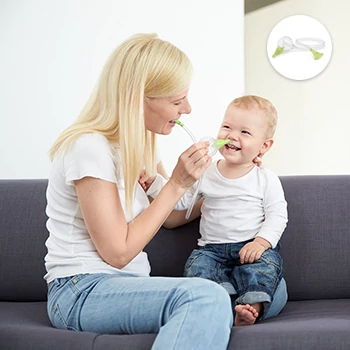 A woman clearing the nose of her smiling son with the help of the Nosiboo Eco Manual Nasal Aspirator