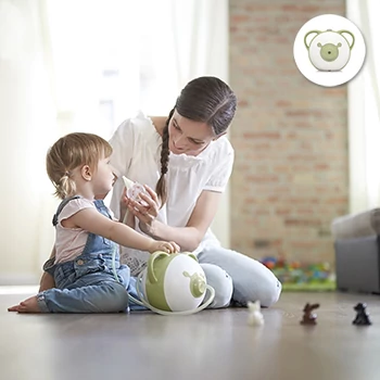 A mother clearing her daughter's nose with the help of the Nosiboo Pro Electric Nasal Aspirator while sitting on the floor at home